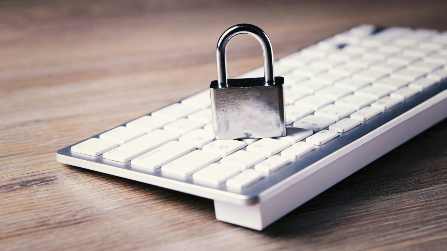 Padlock resting on a white keyboard, representing customer data privacy